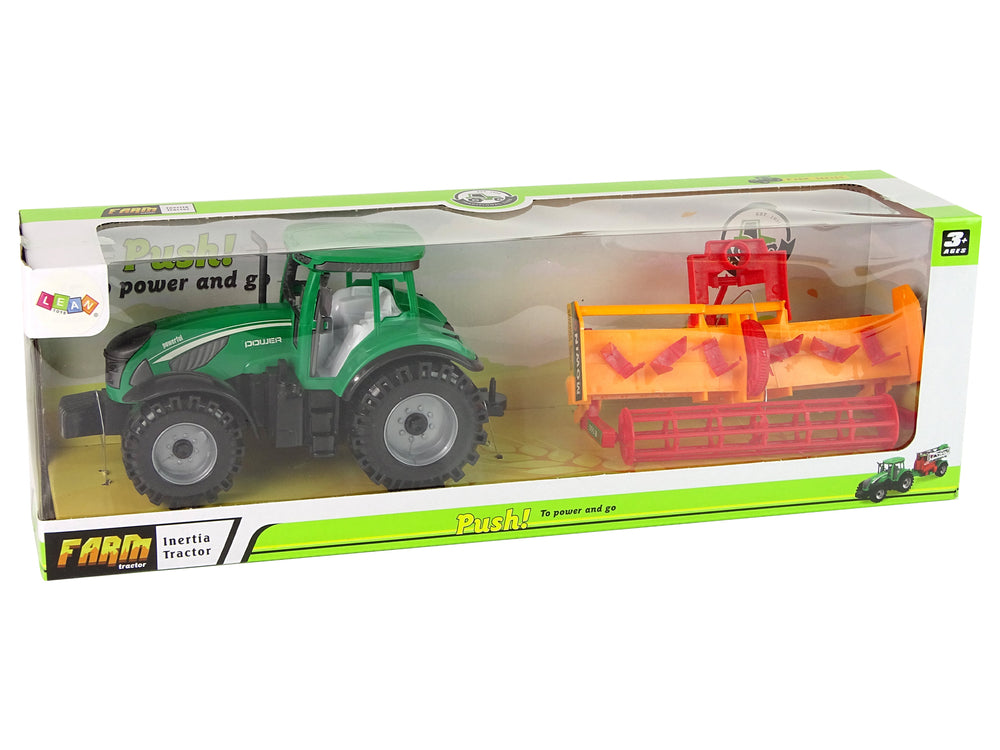 Grüner Traktor mit orangefarbenem Grubber für Kinder